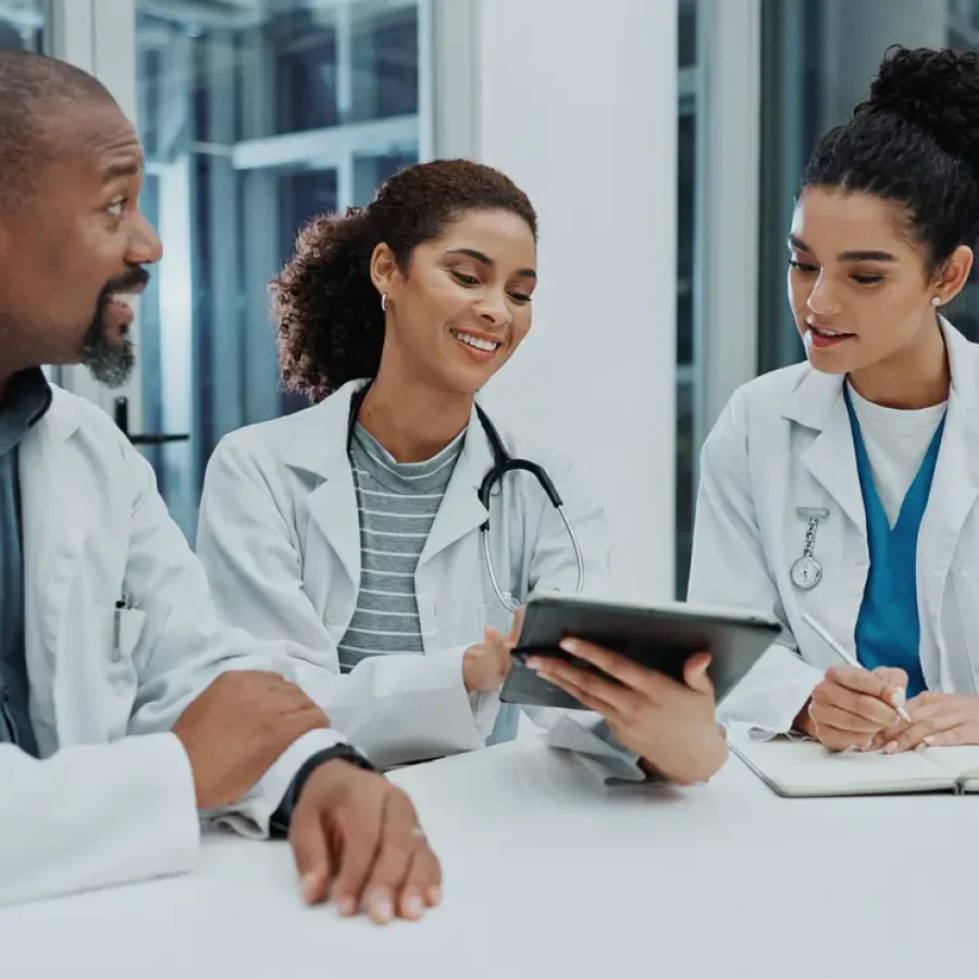 People, doctor and team with tablet in meeting for healthcare, communication or news at hospital. Group of medical employees with smile on technology for discussion, ideas or online app at clinic